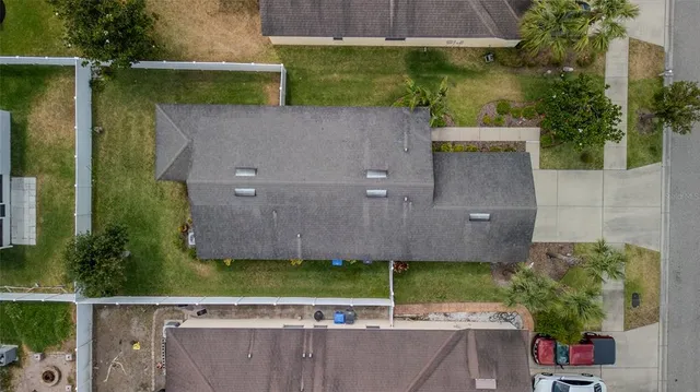 an aerial view of a house with a yard basket ball court and outdoor seating