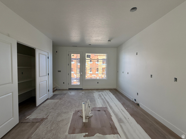 11023 South Freestone Road, Unit 122 South Jordan, UT 84009 - Photo 6 of 12 Bright interior space featuring a glass-paneled door, a large window, recessed lighting, and wood-finish flooring
