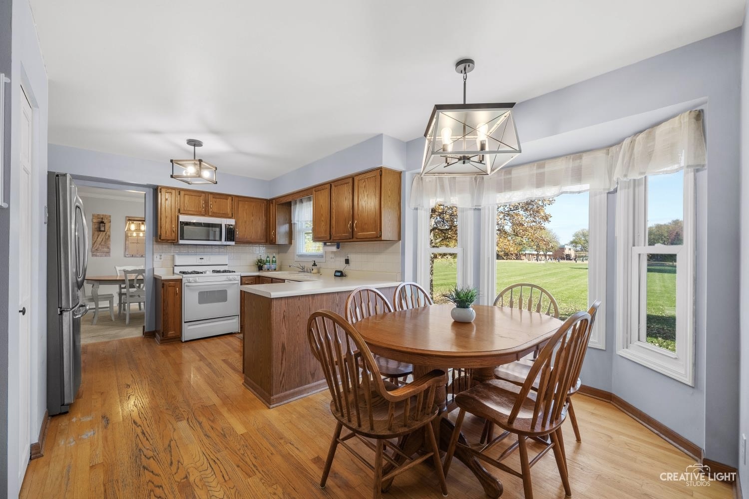 1348 Midway Avenue St. Charles, IL 60174 - Photo 7 of 23 a dining room with furniture a chandelier and wooden floor