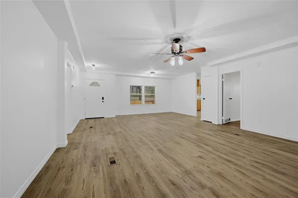 wooden floor in an empty room with a window