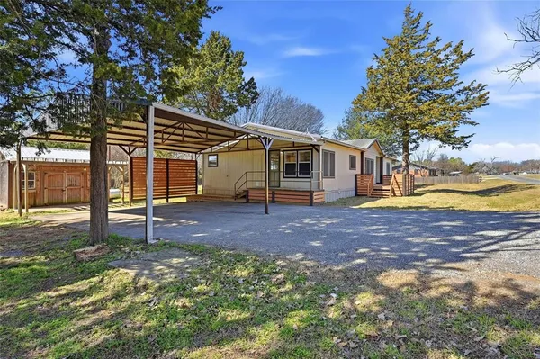 a view of a house with backyard and sitting area