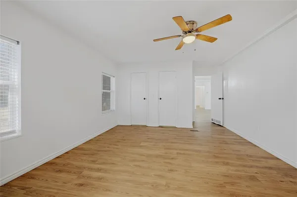 a view of empty room with ceiling fan