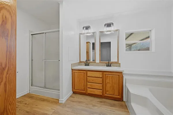 a spacious bathroom with a double vanity sink and a mirror