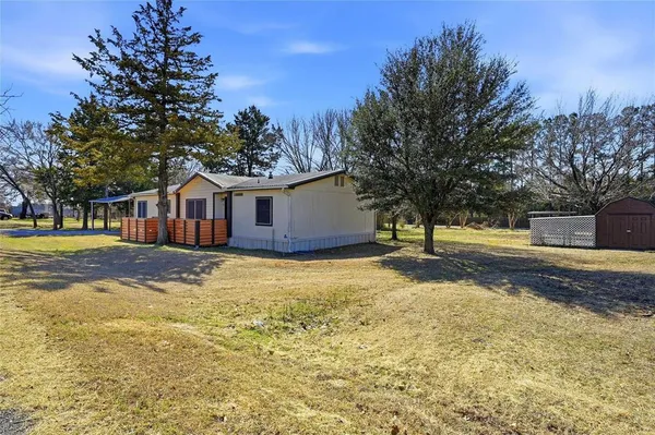 a view of a house with snow on the road