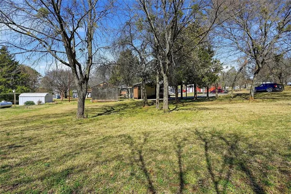 a swimming pool with trees in the background