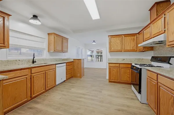 a kitchen with stainless steel appliances granite countertop a sink and cabinets