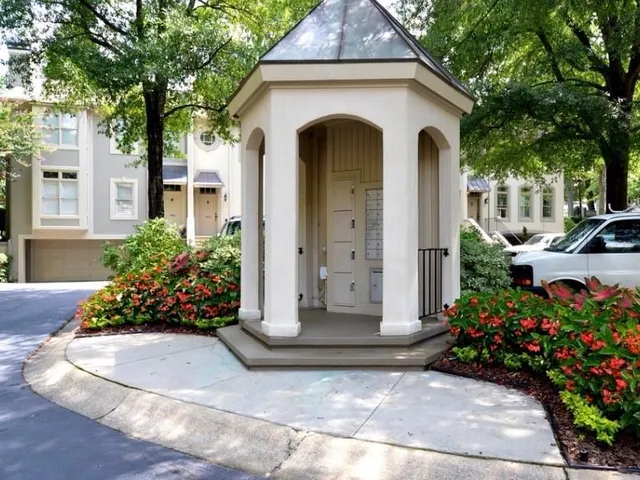a backyard of a house with a yard and outdoor seating