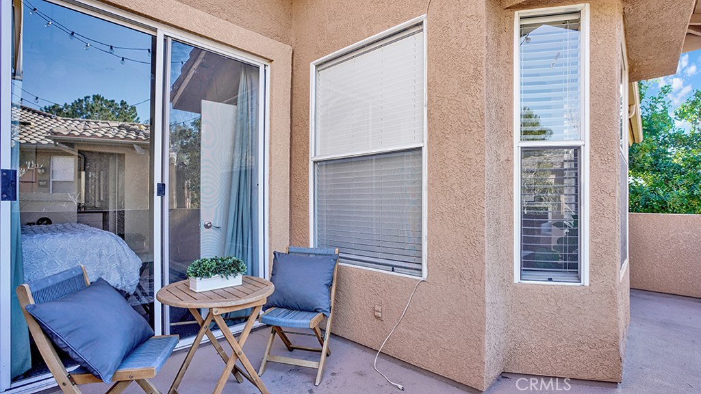 19431-57d Rue De Valore Lake Forest, CA 92610 - Photo 24 of 31 a view of a house with a dining table and chairs in porch