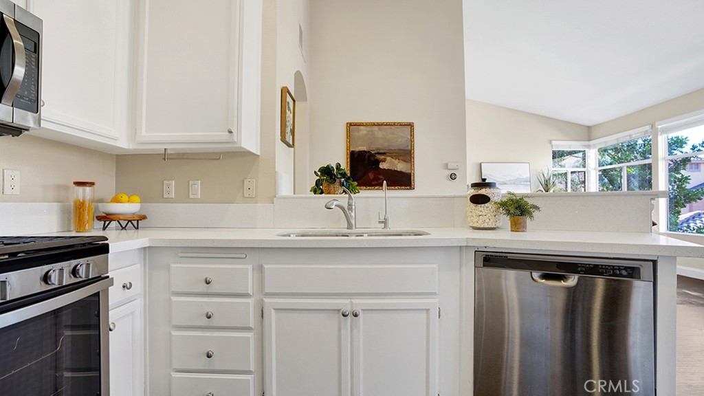 19431-57d Rue De Valore Lake Forest, CA 92610 - Photo 10 of 31 a kitchen with white cabinets and a sink
