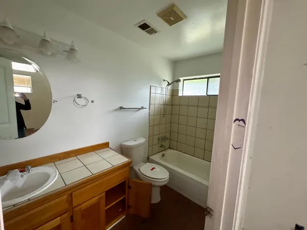 a bathroom with a toilet a sink and mirror
