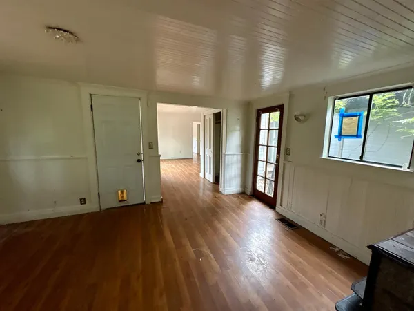 wooden floor in an empty room with a fireplace