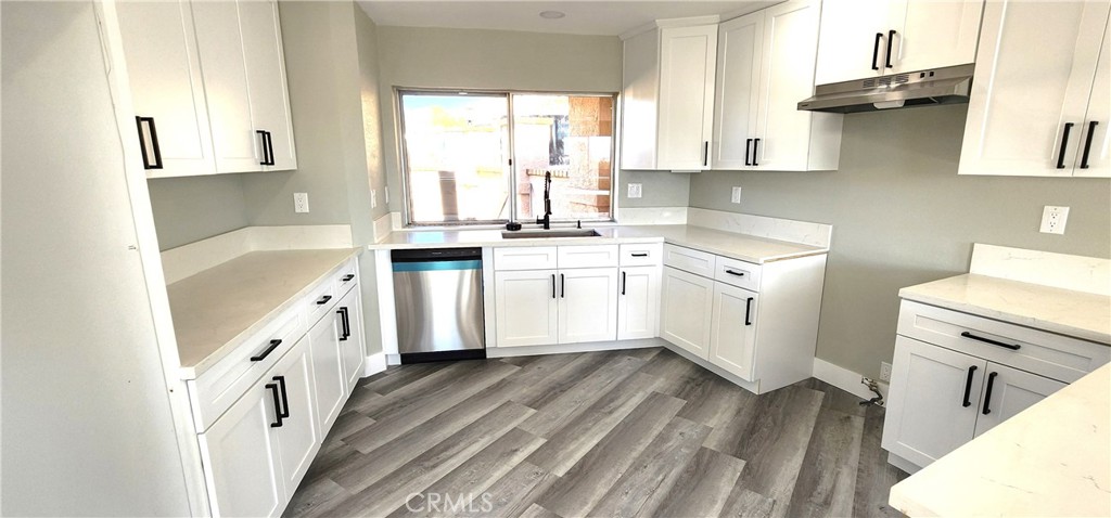 16257 St Timothy Road Apple Valley, CA 92307 - Photo 13 of 28 a kitchen with a sink a stove and cabinets