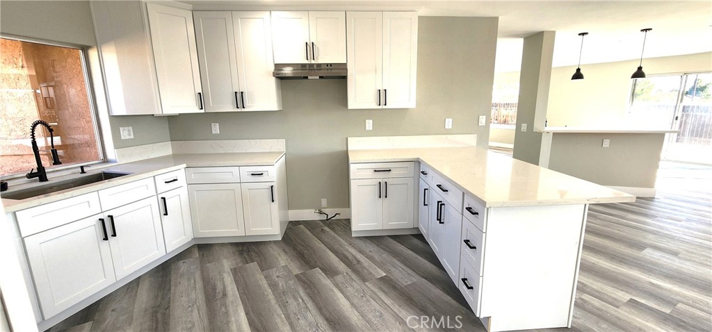 16257 St Timothy Road Apple Valley, CA 92307 - Photo 14 of 28 a kitchen with cabinets appliances and a window