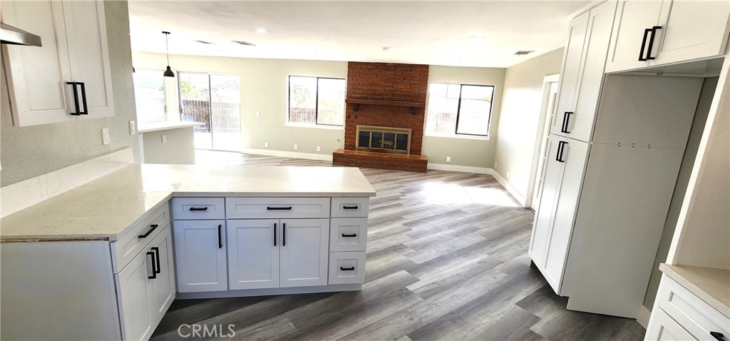 16257 St Timothy Road Apple Valley, CA 92307 - Photo 15 of 28 a view of a kitchen cabinets and wooden floor