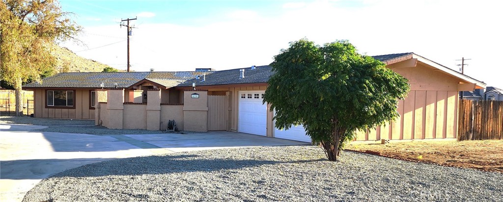 16257 St Timothy Road Apple Valley, CA 92307 - Photo 2 of 28 a front view of a house with a garden