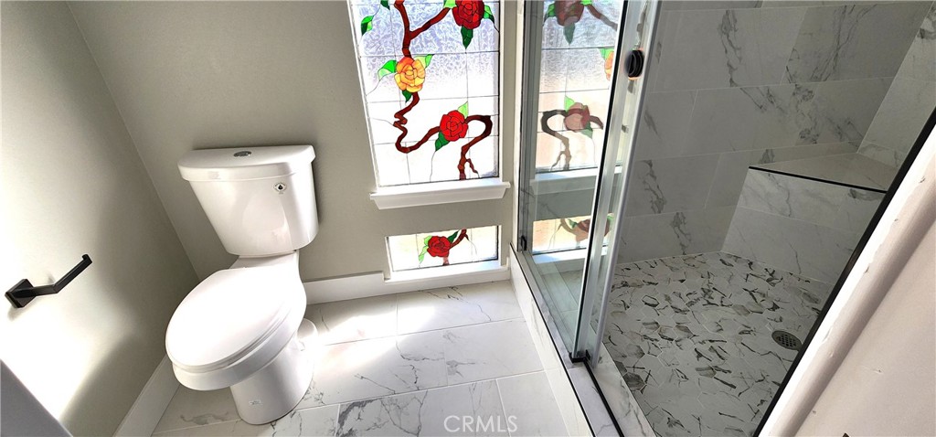 16257 St Timothy Road Apple Valley, CA 92307 - Photo 25 of 28 a bathroom with a toilet and a shower curtain