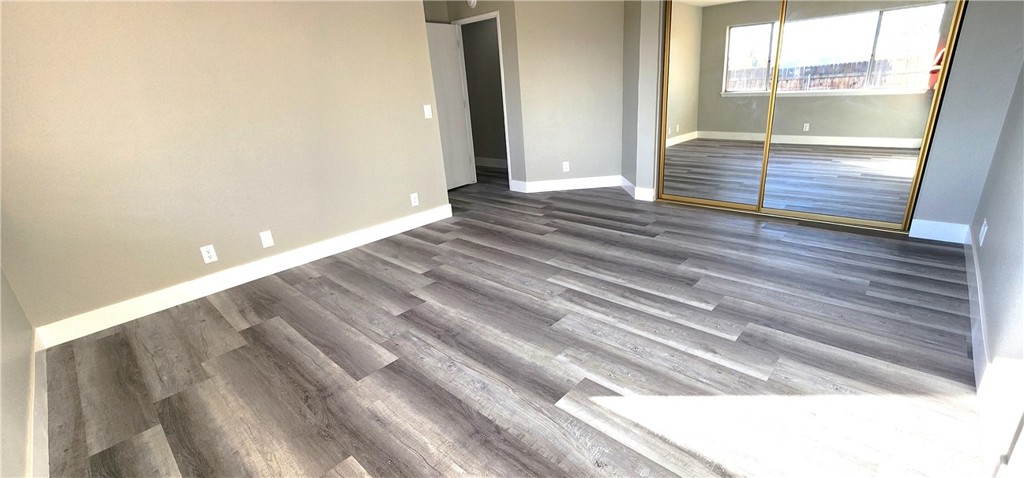 16257 St Timothy Road Apple Valley, CA 92307 - Photo 26 of 28 a view of wooden floor and windows in a room