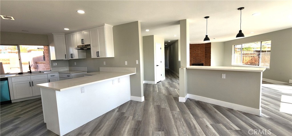 16257 St Timothy Road Apple Valley, CA 92307 - Photo 9 of 28 a kitchen with a sink stove and wooden cabinets