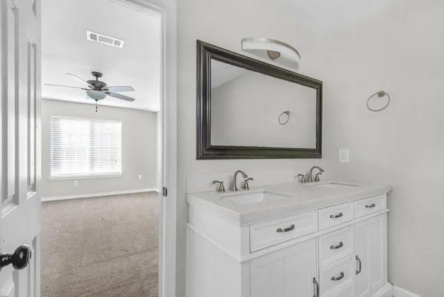 a bathroom with a double vanity sink and mirror
