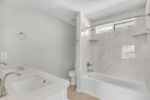 a bathroom with a bathtub and a shower