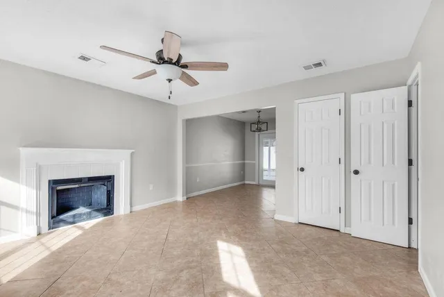 a view of an empty room with a fireplace