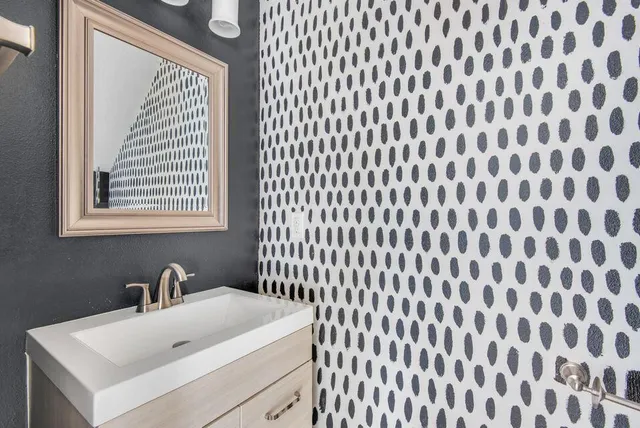 a bathroom with a sink and a mirror