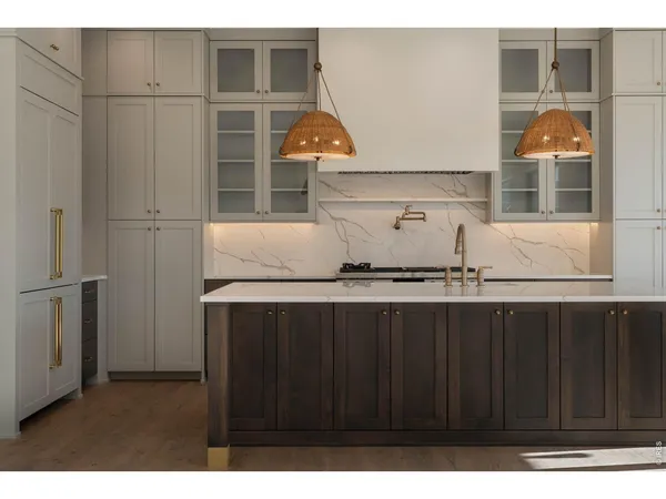 a kitchen with stainless steel appliances a sink cabinets and wooden floor