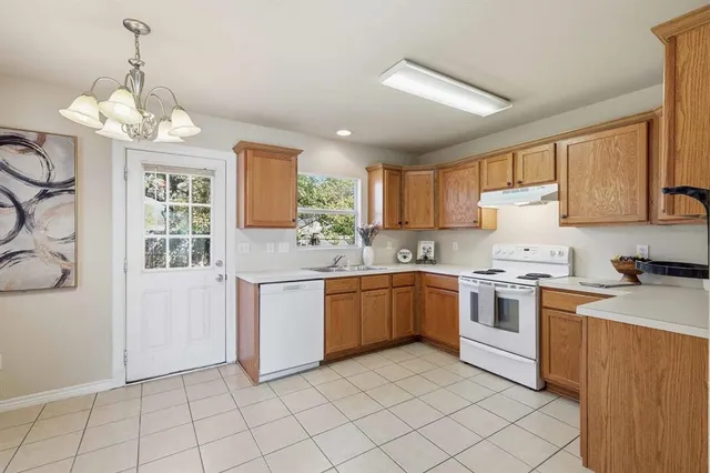 a kitchen with a stove a sink and a refrigerator