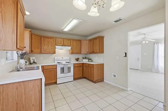 a kitchen with a stove a sink and a refrigerator
