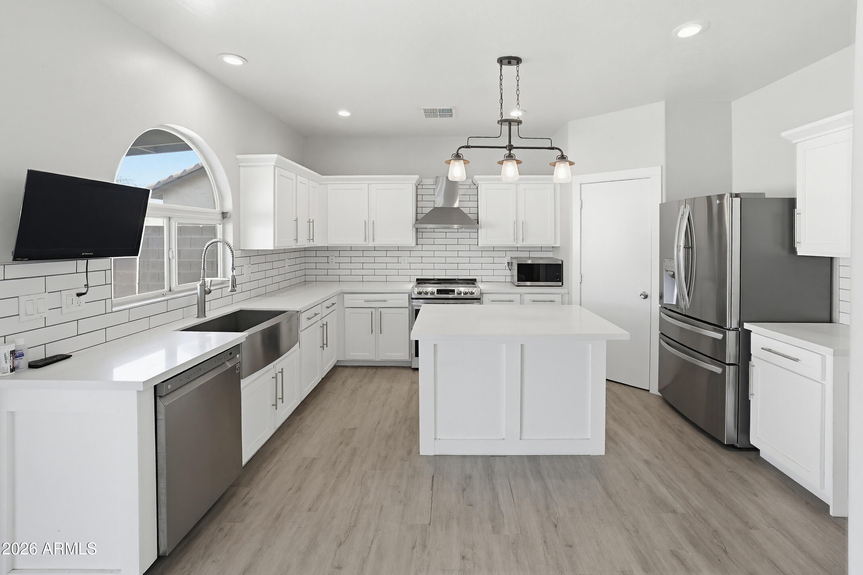 3818 West Carson Road Phoenix, AZ 85041 - Photo 12 of 41 a kitchen with stainless steel appliances white cabinets a sink a stove a refrigerator and a oven