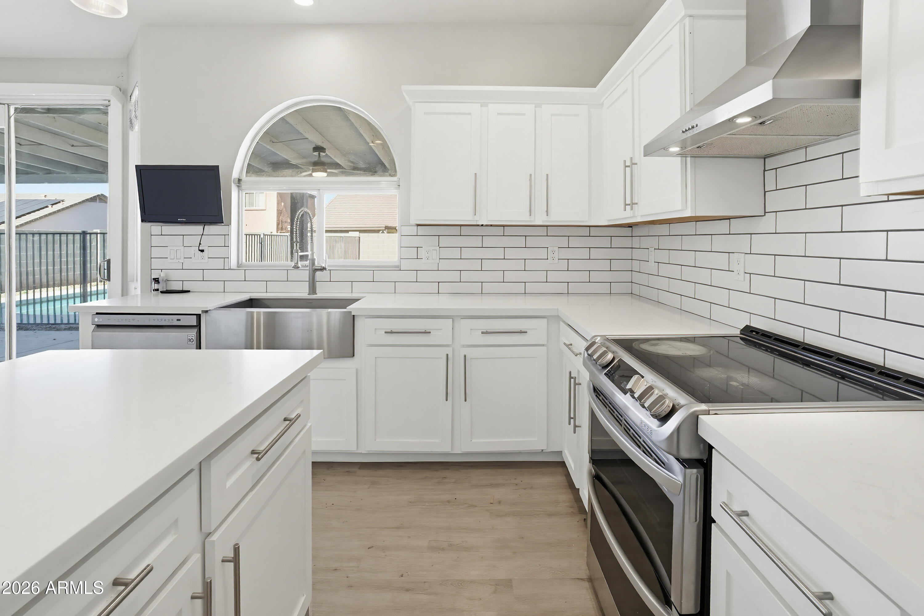 3818 West Carson Road Phoenix, AZ 85041 - Photo 15 of 41 a kitchen with white cabinets and white appliances