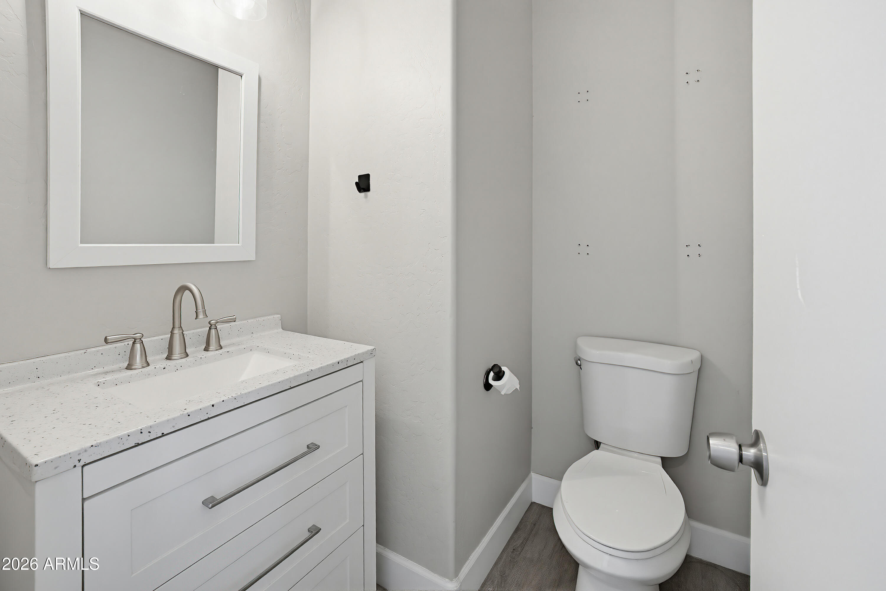 3818 West Carson Road Phoenix, AZ 85041 - Photo 16 of 41 a bathroom with a granite countertop toilet sink and mirror