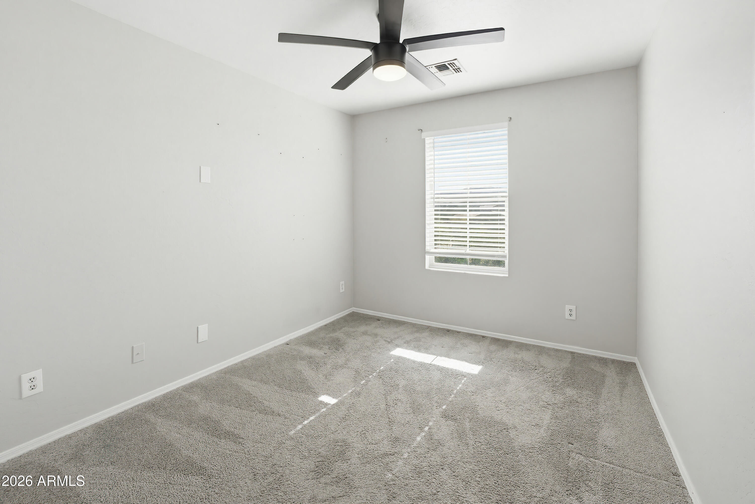 3818 West Carson Road Phoenix, AZ 85041 - Photo 28 of 41 a view of an empty room with a window