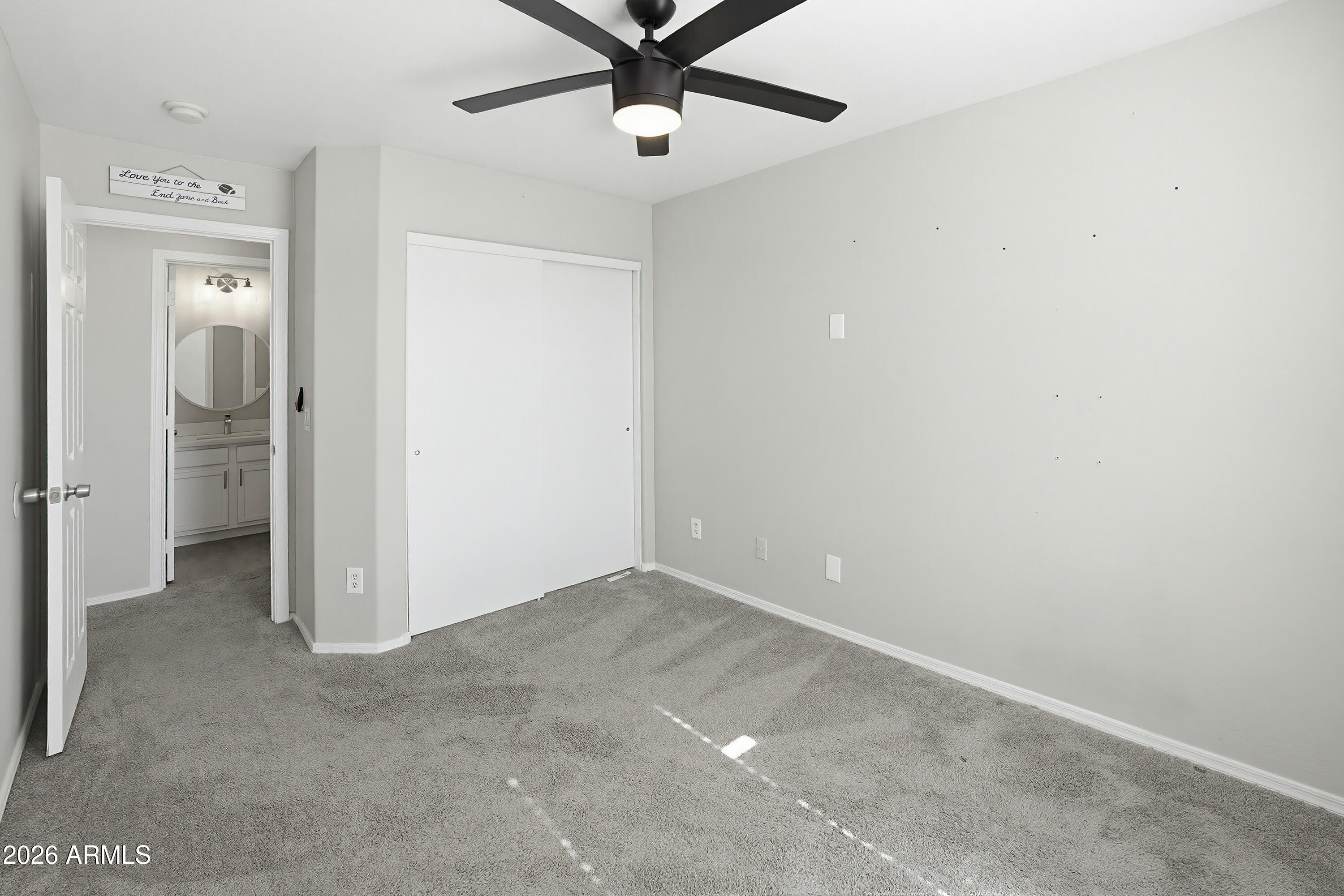 3818 West Carson Road Phoenix, AZ 85041 - Photo 30 of 41 an empty room with closet and a chandelier fan