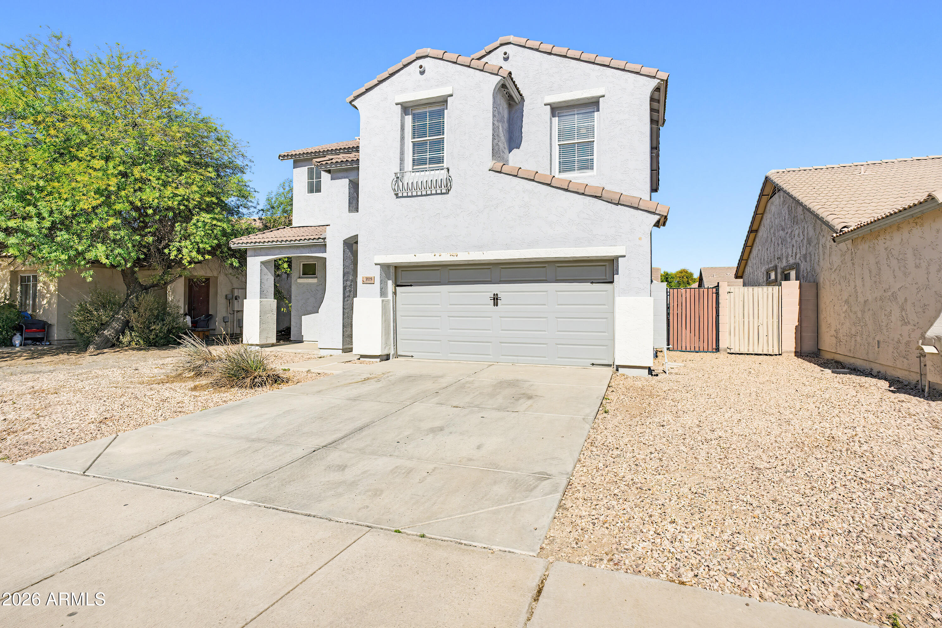 3818 West Carson Road Phoenix, AZ 85041 - Photo 3 of 41 a front view of a house with a yard and garage