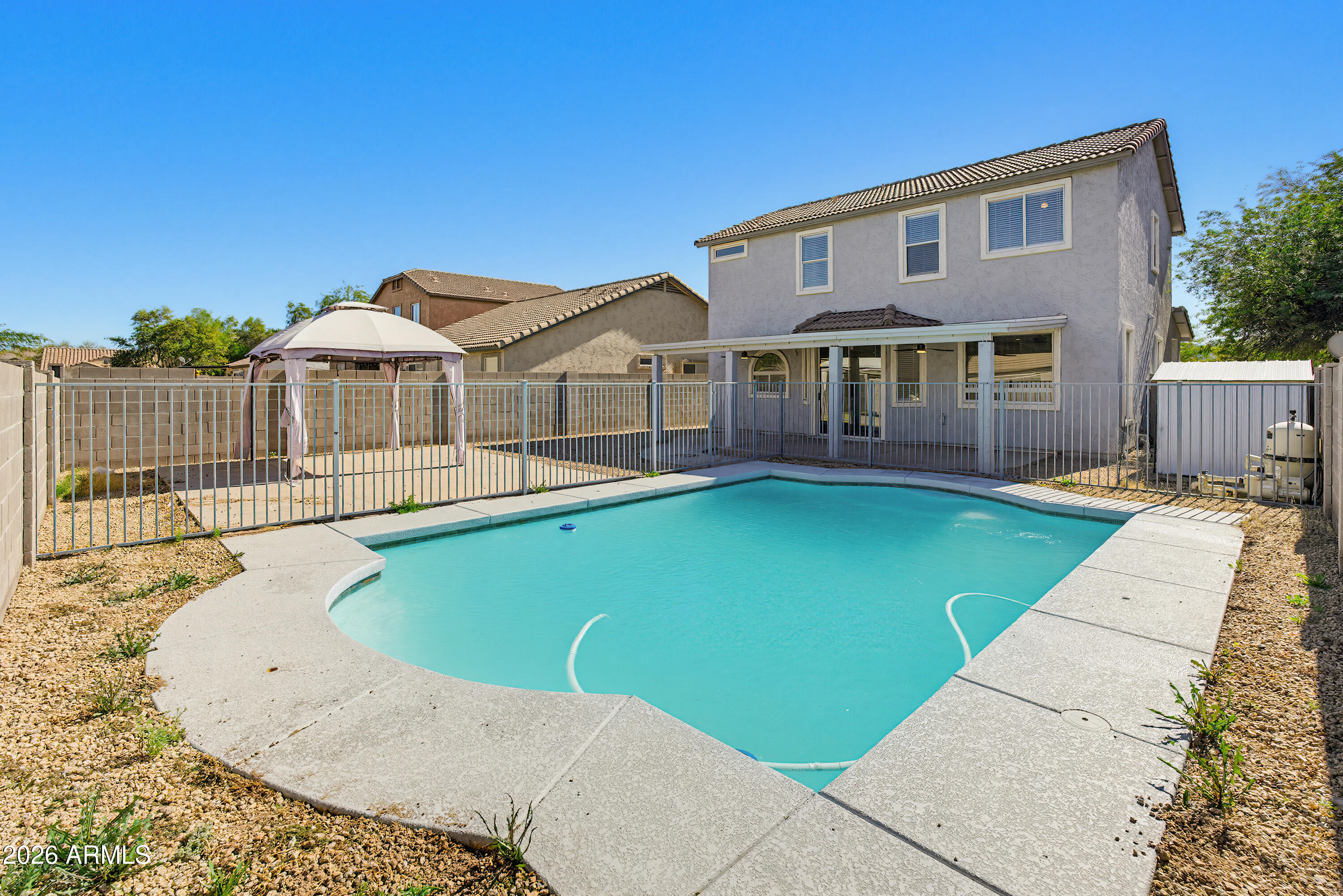 3818 West Carson Road Phoenix, AZ 85041 - Photo 38 of 41 a front view of a house with a garden and yard