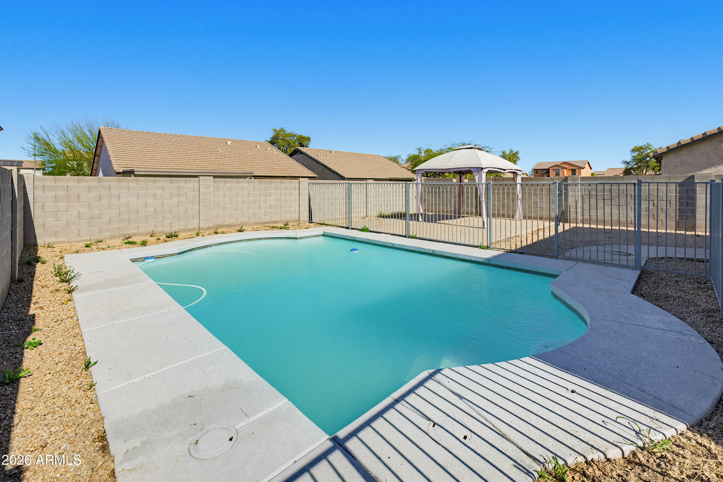 3818 West Carson Road Phoenix, AZ 85041 - Photo 39 of 41 a view of a swimming pool with an outdoor seating