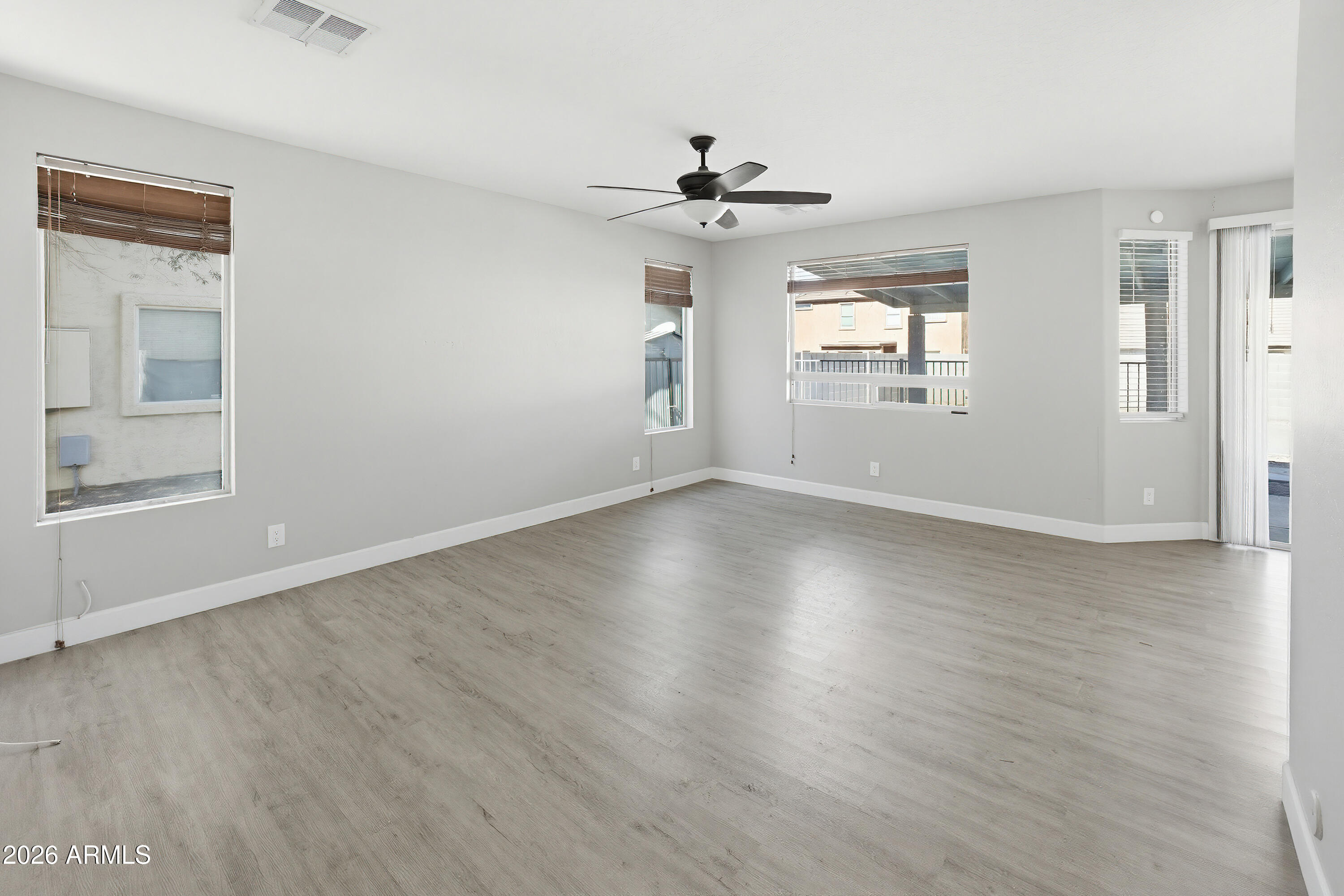 3818 West Carson Road Phoenix, AZ 85041 - Photo 5 of 41 a view of wooden floor and windows in a room
