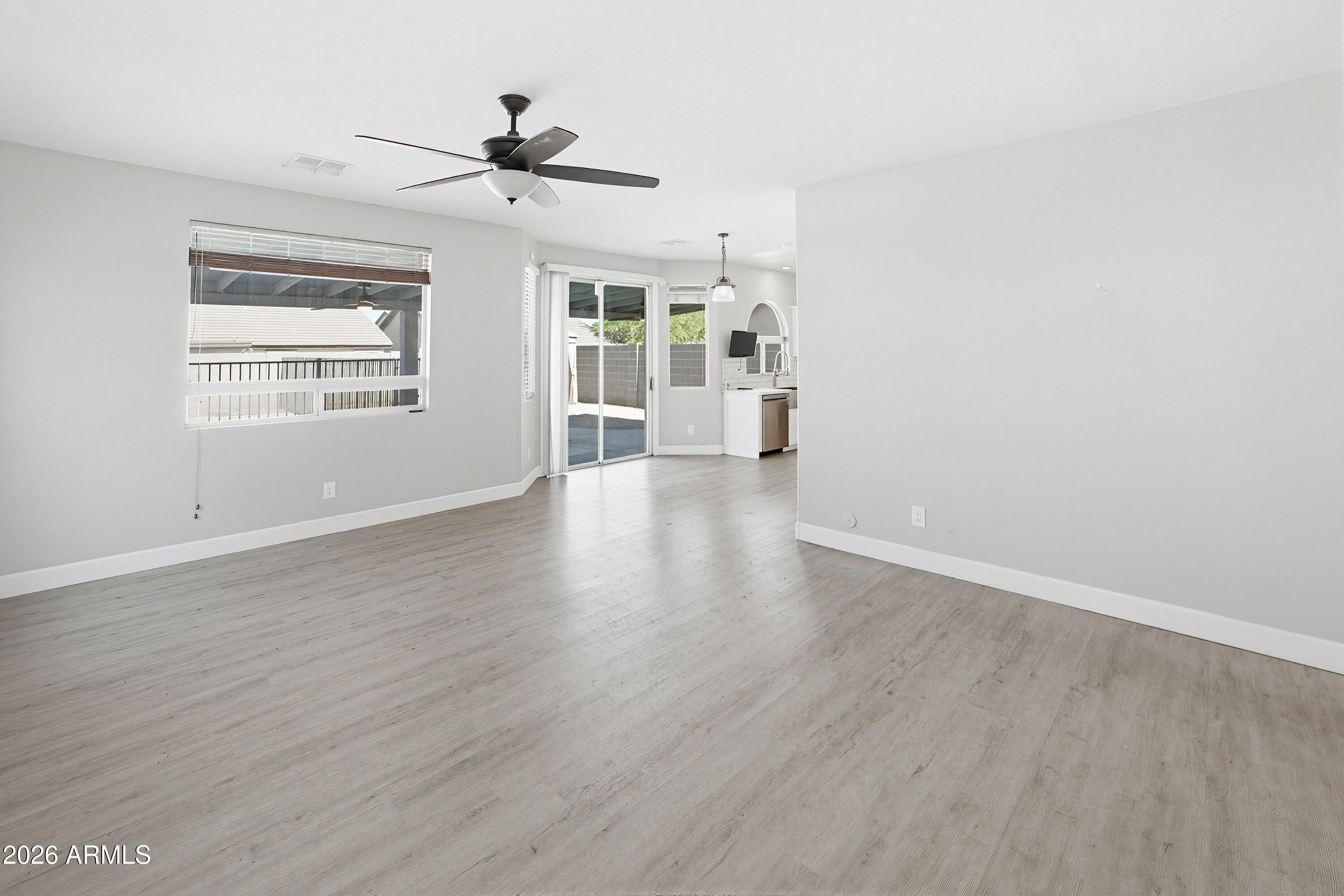 3818 West Carson Road Phoenix, AZ 85041 - Photo 6 of 41 wooden floor in an empty room with a window