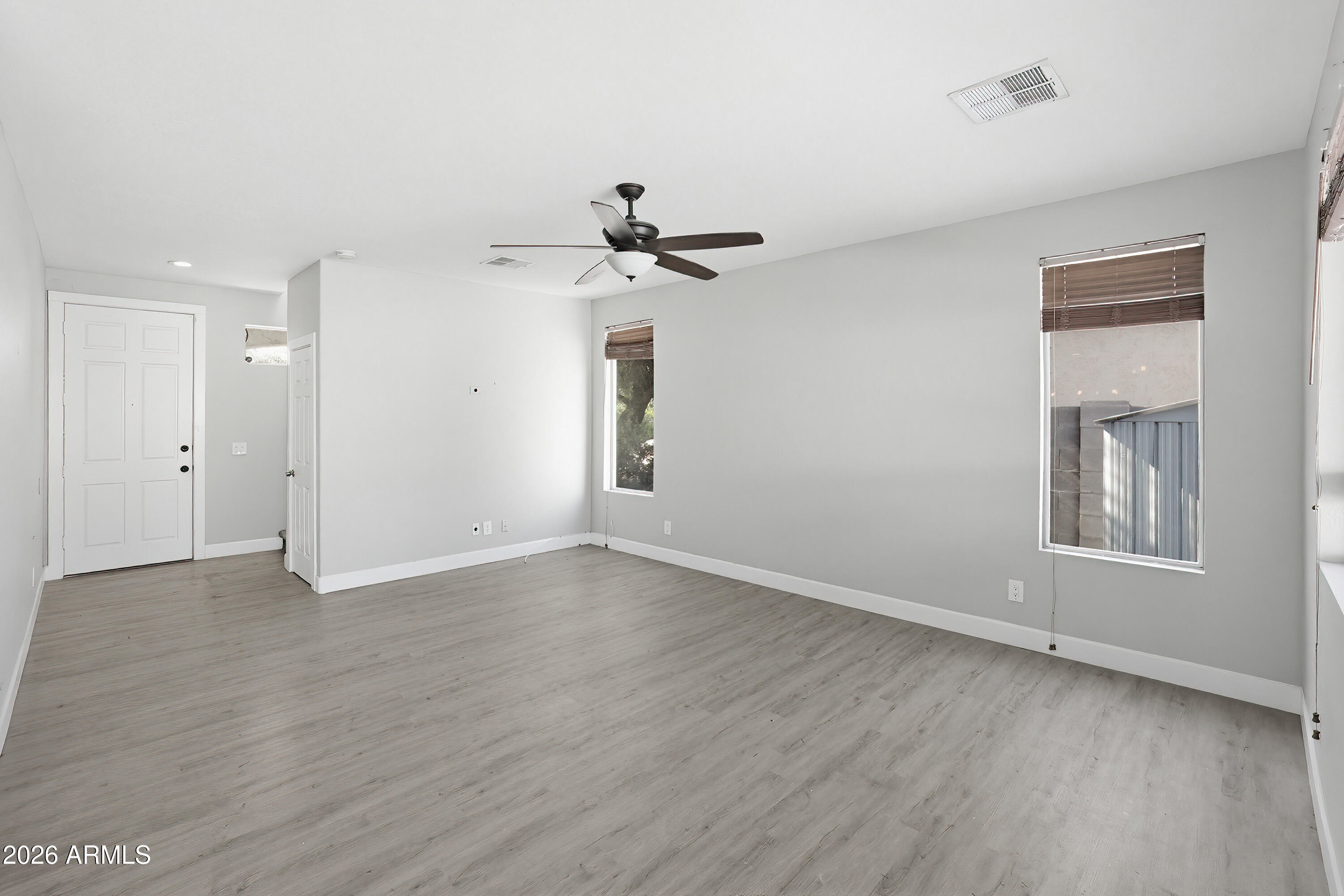 3818 West Carson Road Phoenix, AZ 85041 - Photo 7 of 41 wooden floor in an empty room with a window