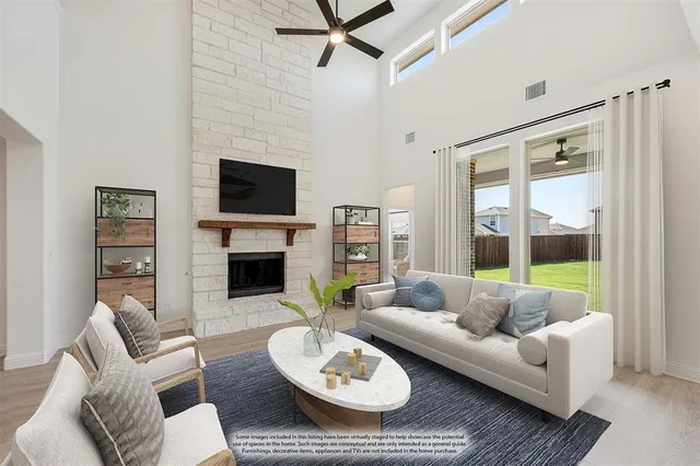 a living room with furniture a fireplace and a large window
