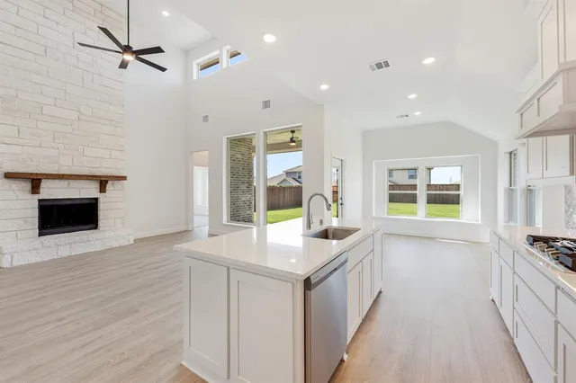 a open kitchen with granite countertop a stove and a sink