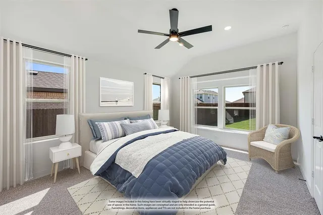 a bedroom with a bed a couch and a large window