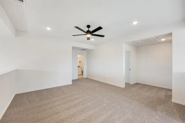 a view of an empty room and a ceiling fan
