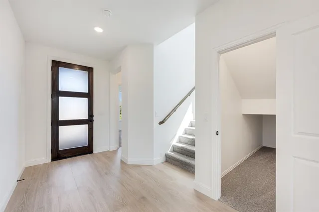 a view of an entryway with wooden floor