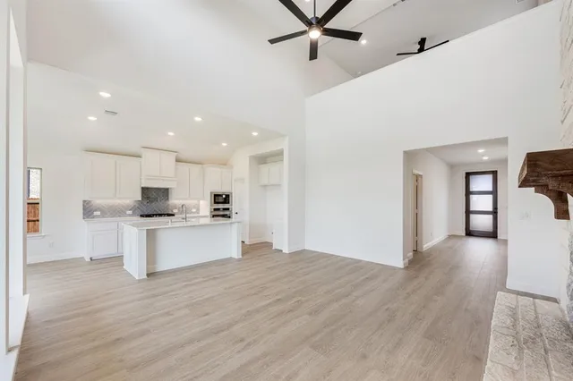 a kitchen with a refrigerator and white cabinets