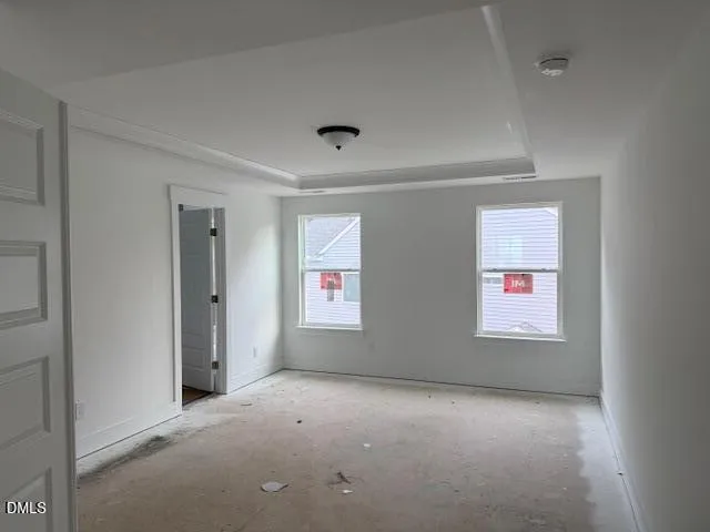 a kitchen that has a lot of white cabinets and stainless steel appliances