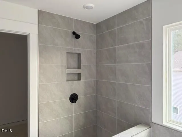 a kitchen with stainless steel appliances granite countertop a stove a sink a refrigerator and white cabinets