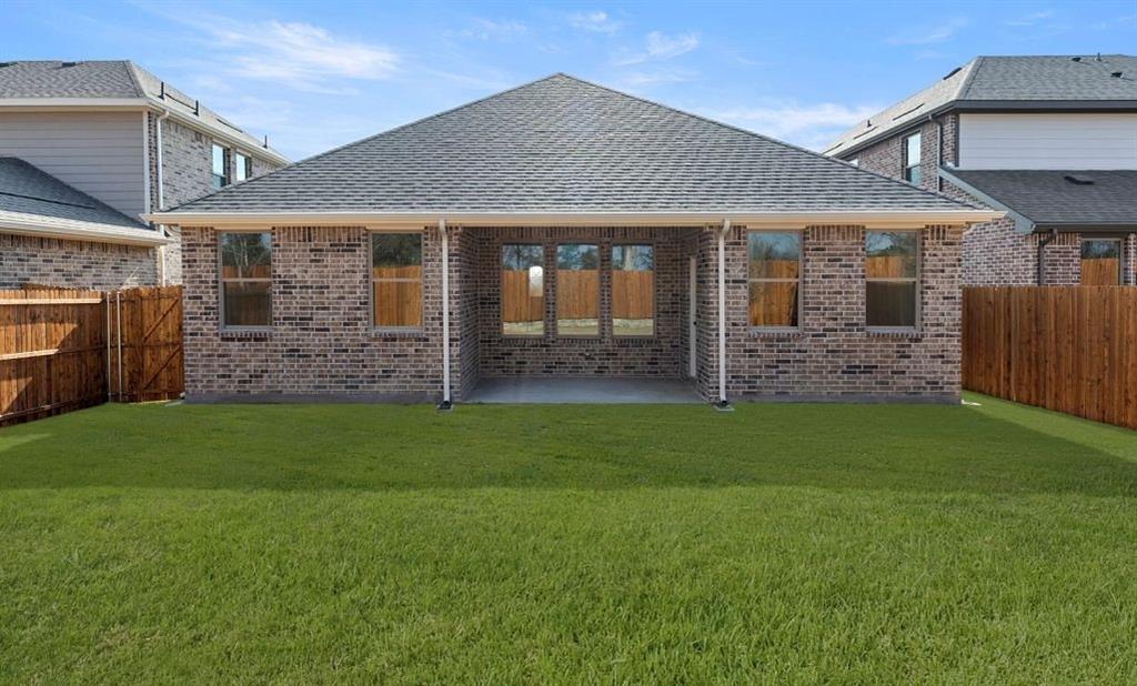 906 Colgate Circle Princeton, TX 75407 - Photo 4 of 16 a front view of a house with a garden
