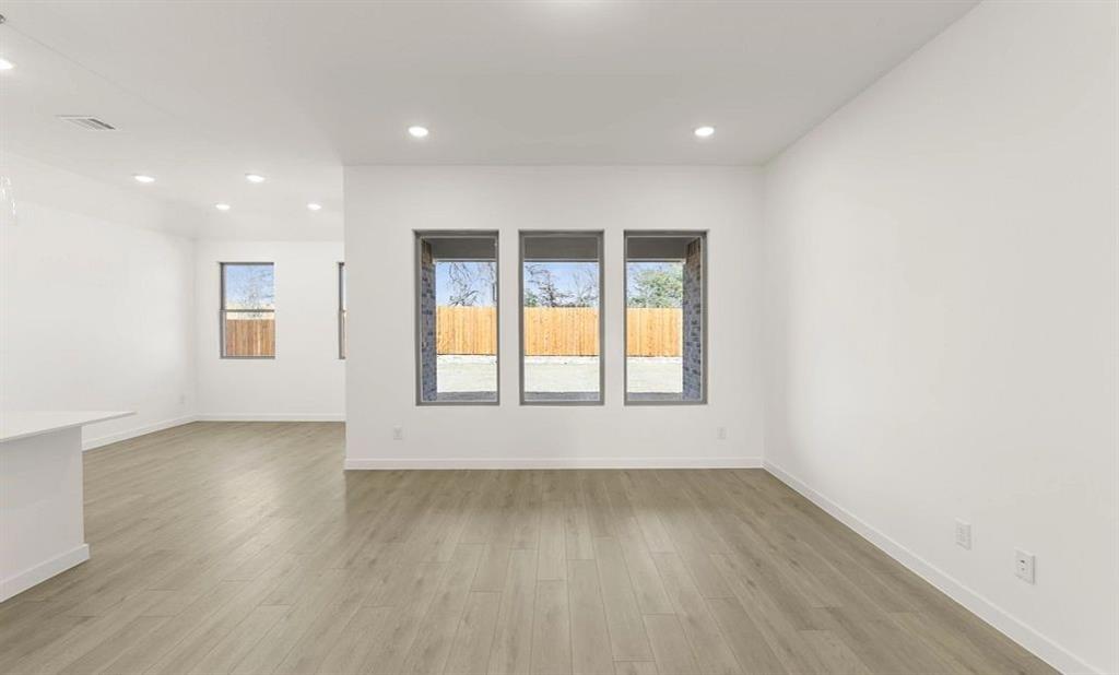 906 Colgate Circle Princeton, TX 75407 - Photo 6 of 16 an empty room with wooden floor and windows